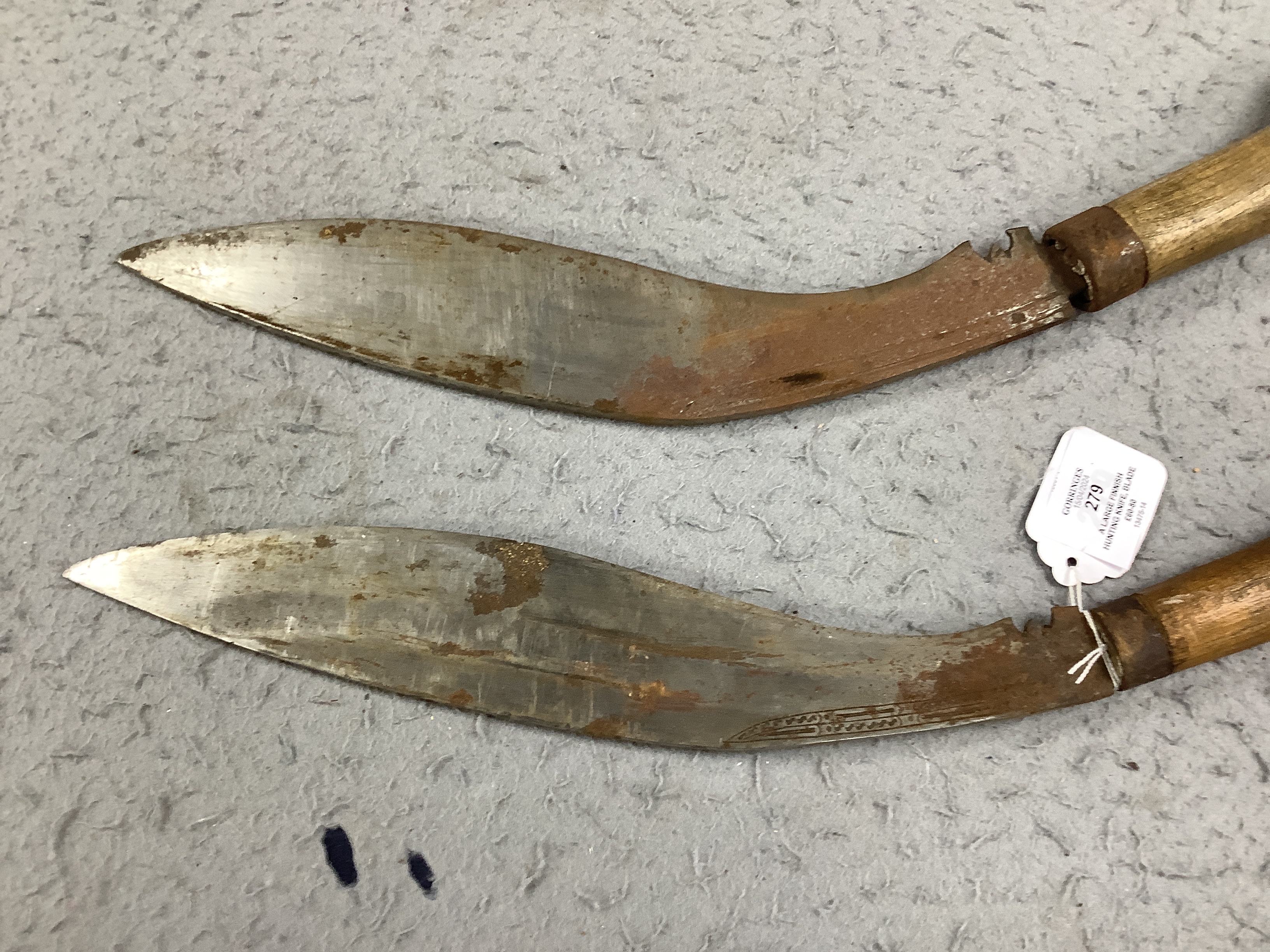 A large Finnish hunting knife, blade dated 1940 and burr wooden handle in its leather sheath, and two Indian kukri in their sheaths